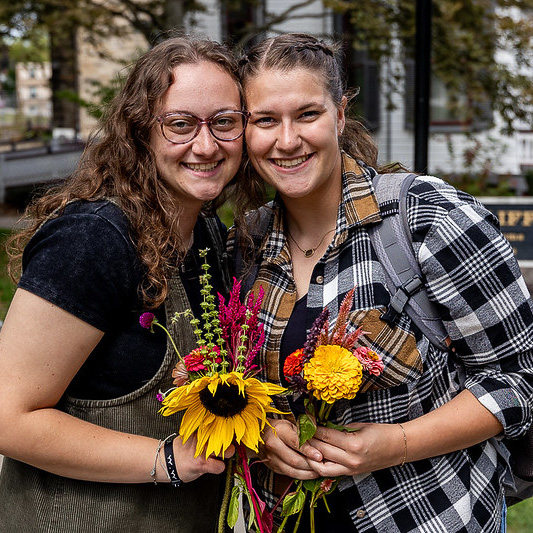 College students with bouquets made from the flower bar