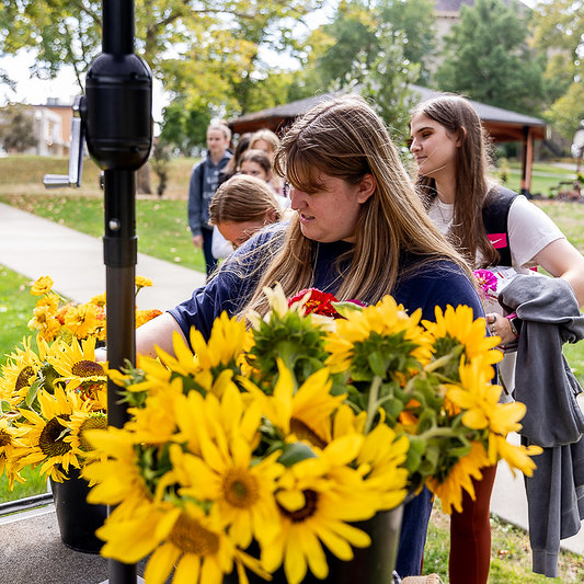 College students lining up for the flower bar