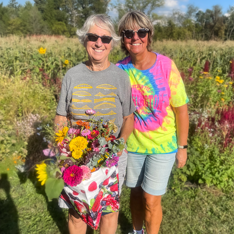 Friends picking flowers on the farm