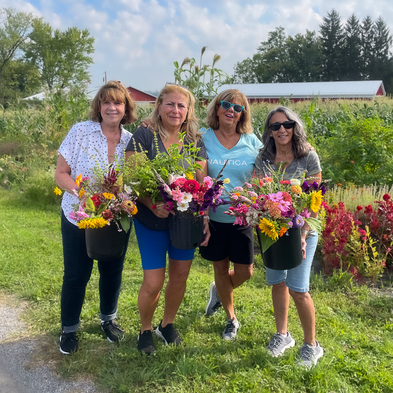 College students picking flowers on the farm